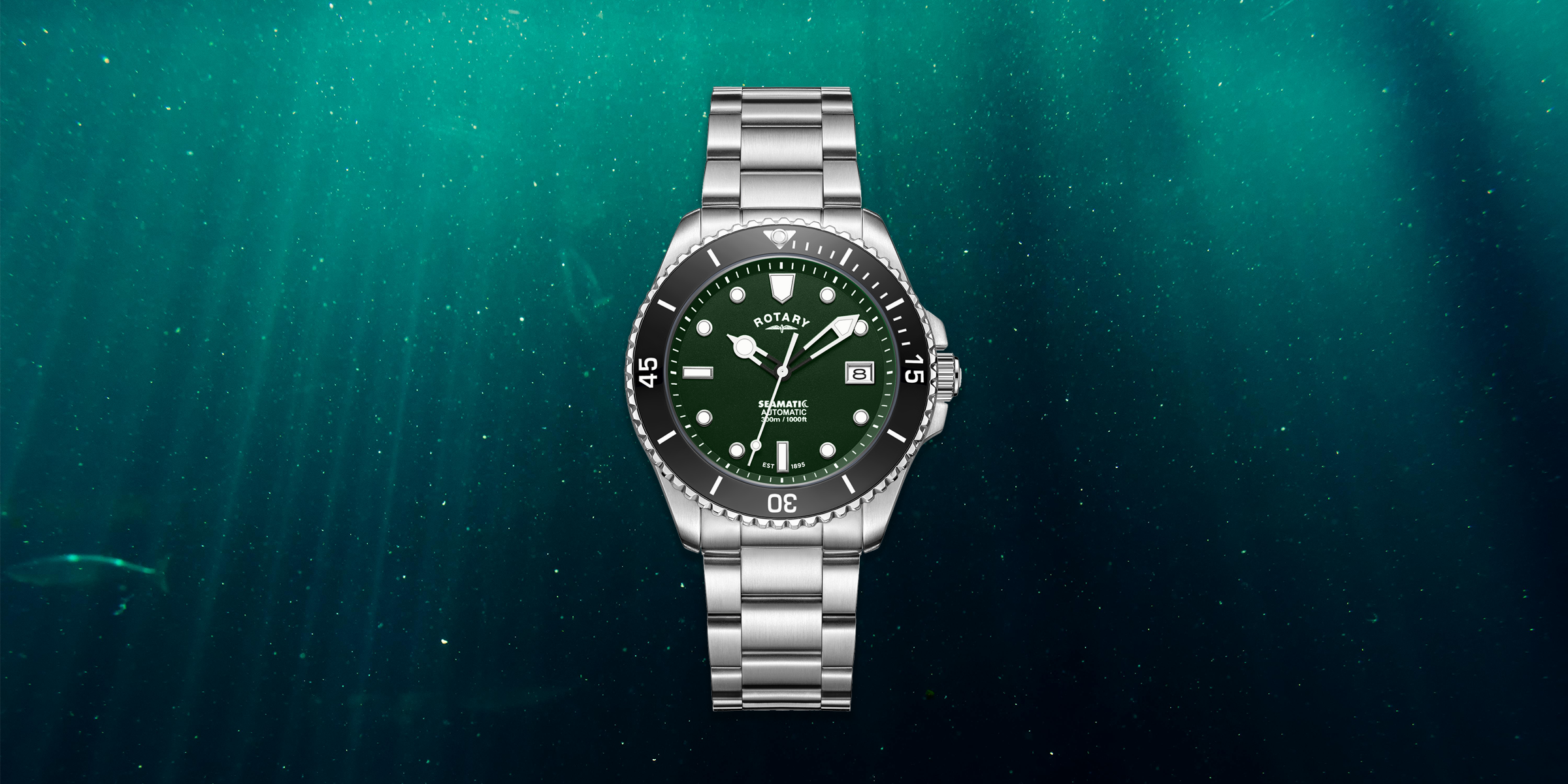 Silver Seamatic watch with a green face on a dark teal underwater background