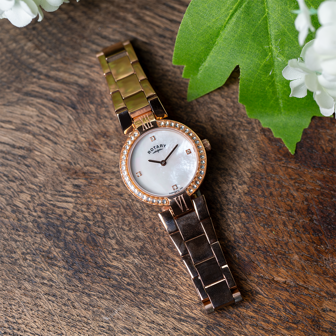 a ladies rose gold rotary watch with a mother of pearl dial and a crystal set bezel