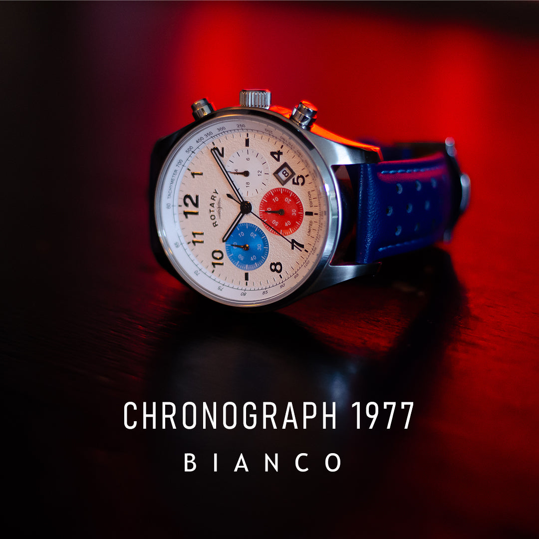 A Rotary Chronograph 1977 Bianco watch sitting on a bar with a neon red glow behind it