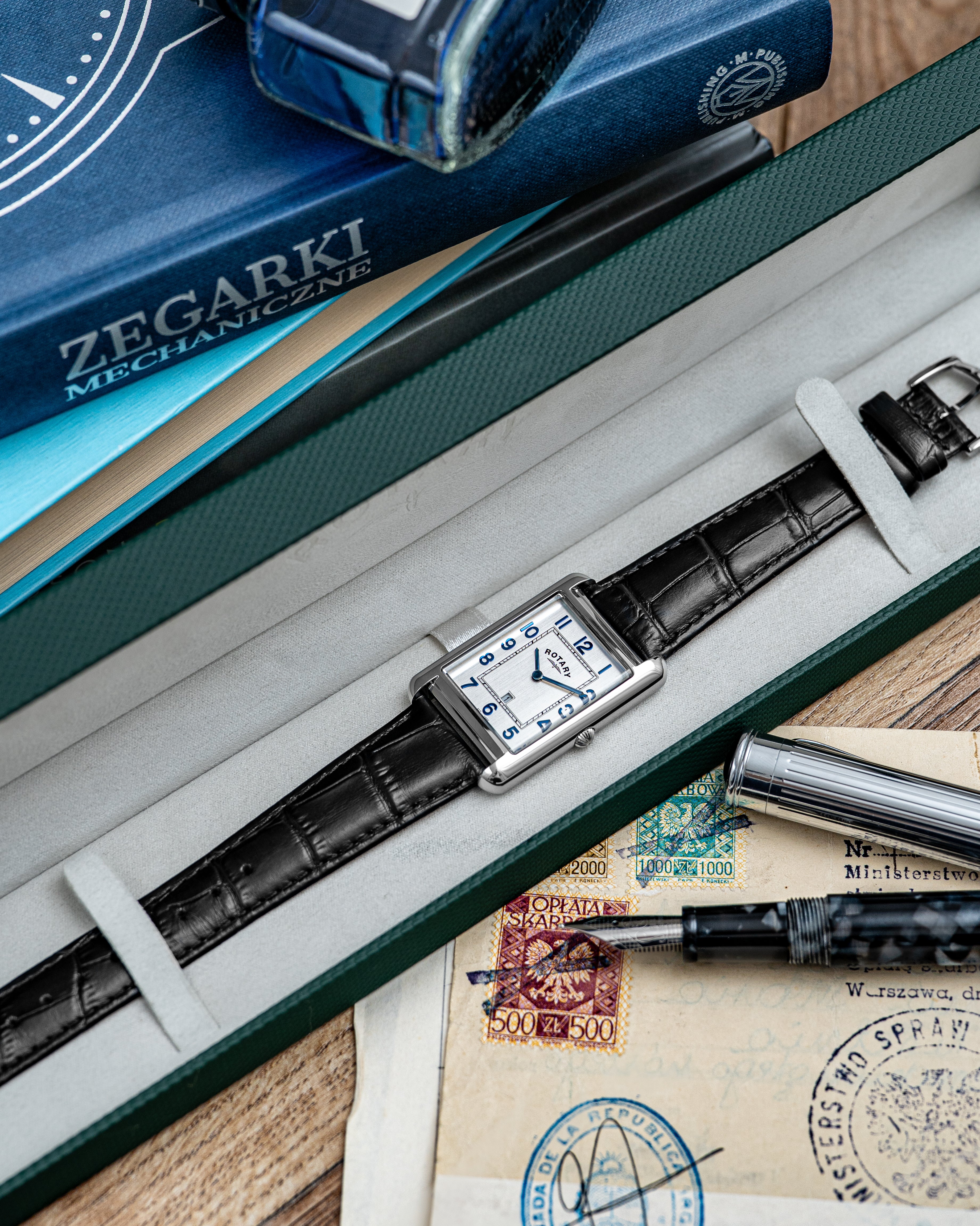 Rotary Heritage Astoria Watch with black leather strap in a box on a wooden surface.