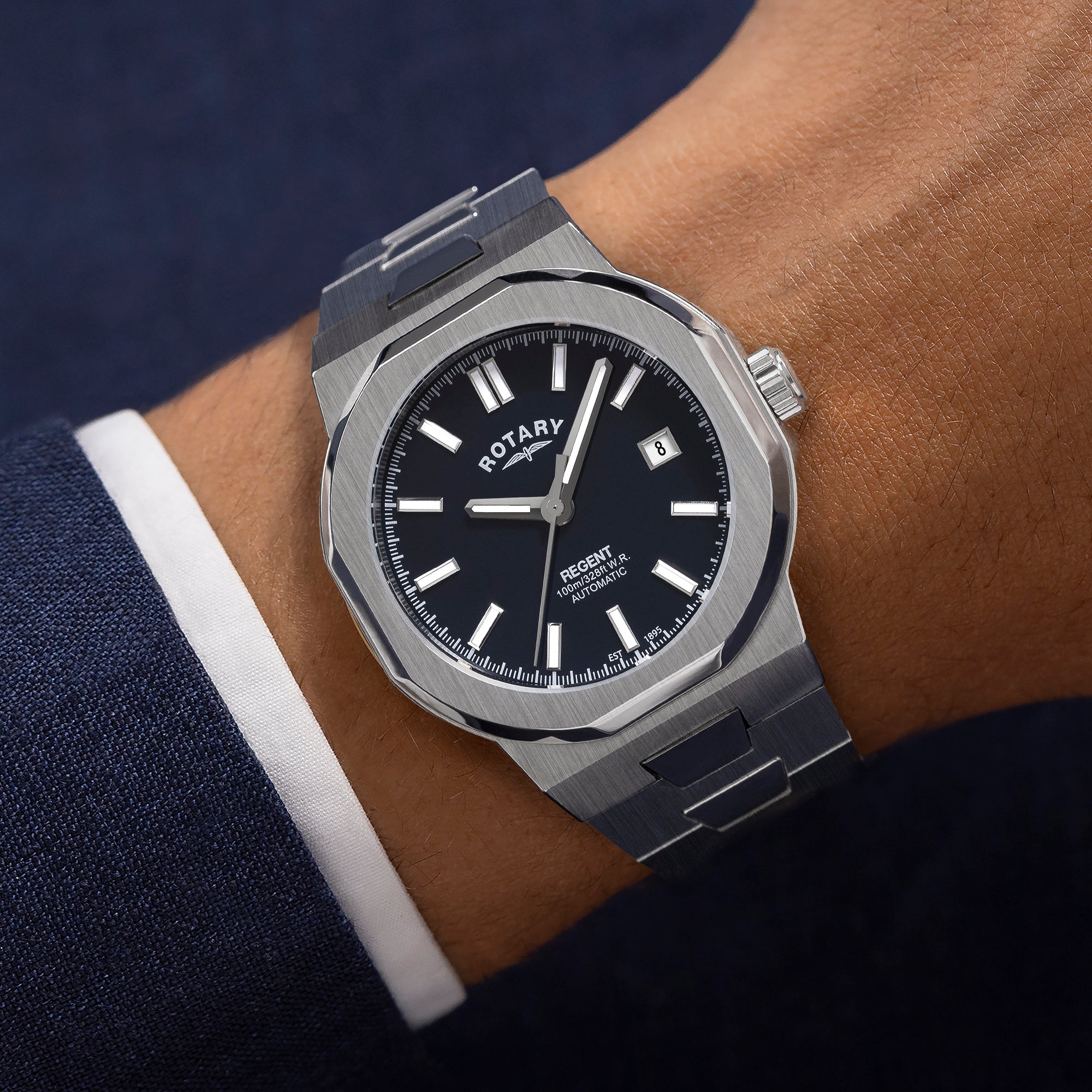 Silver rotary regent automatic watch on a wrist with a dark background