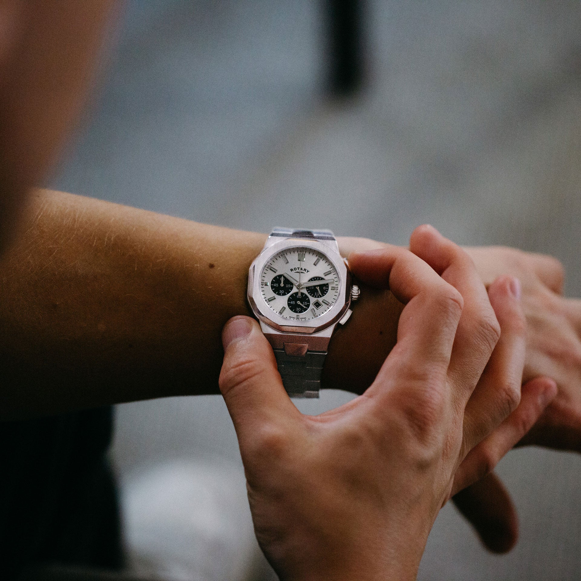 rotary stainless steel chronograph sport watch with an integrated bracelet and white 'panda' style dial