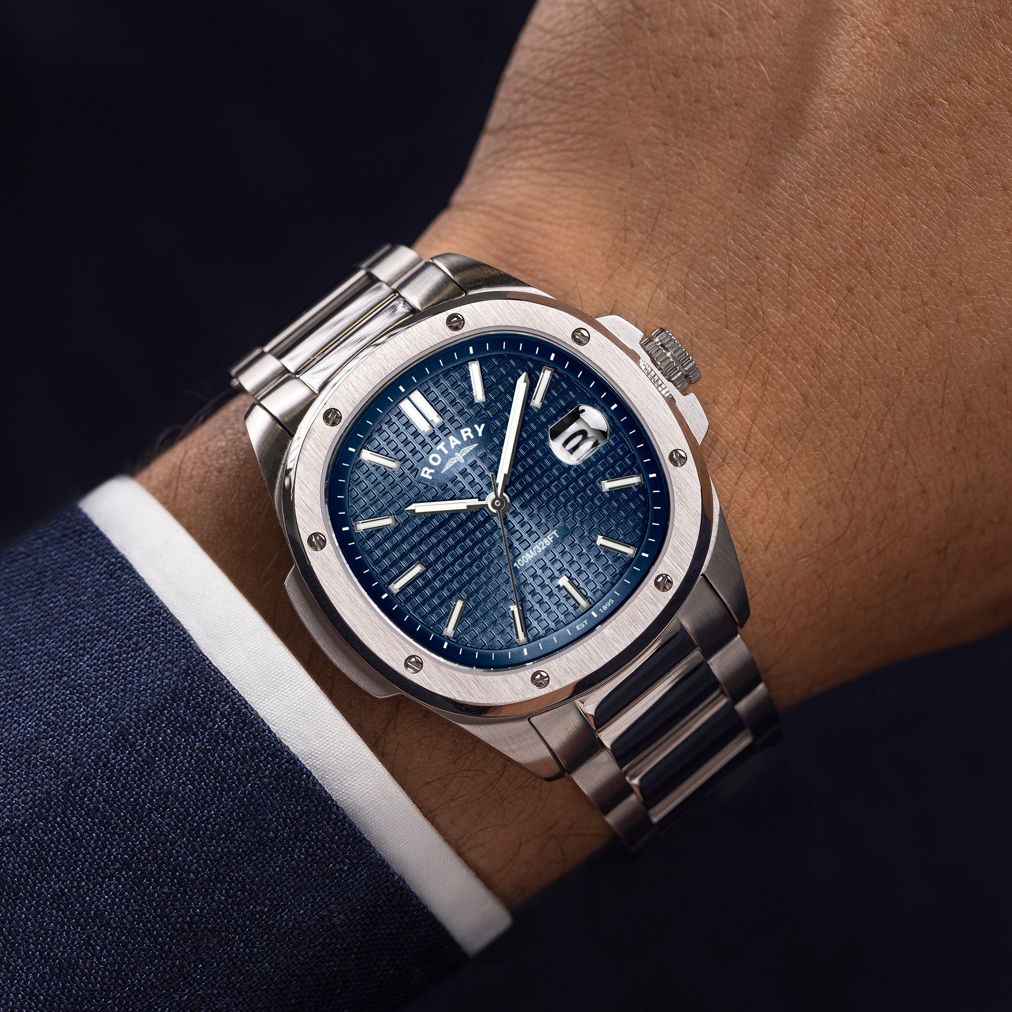 Silver Rotary Apex100 watch with blue dial on a man's wrist