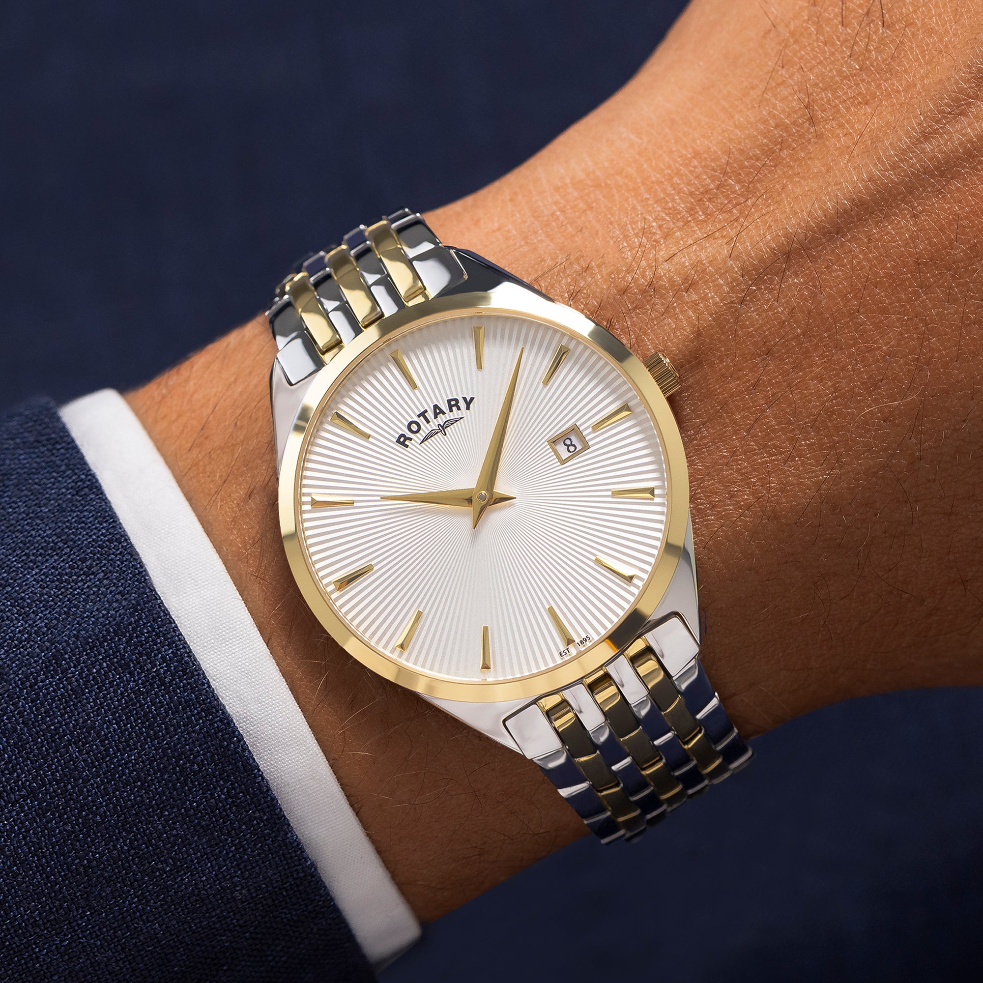 Rotary watch on a wrist with a two-tone metal band