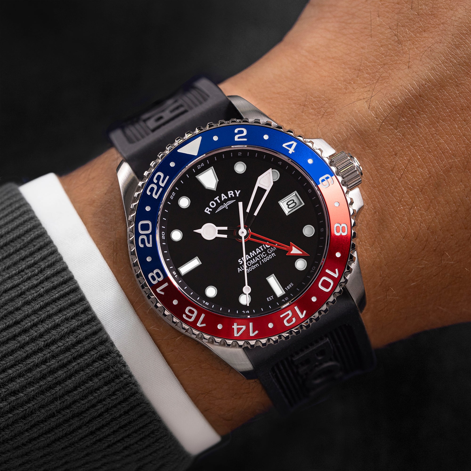 Rotary Seamatic watch with black, red, and blue bezel on a wrist