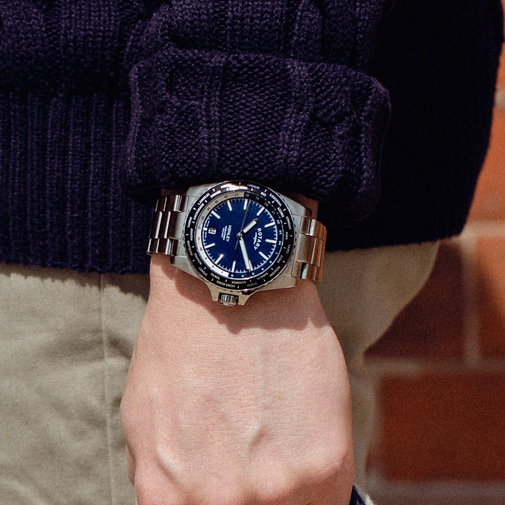A man wearing a rotary mens watch in stainless steel with a blue dial and black bezel