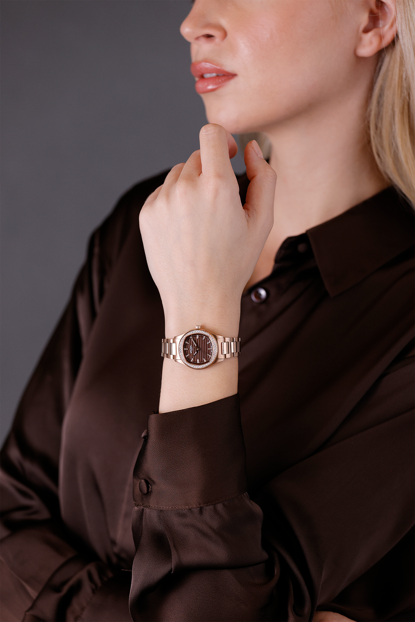 Woman wearing a Rotary Brilliance watch on her wrist with a neutral background