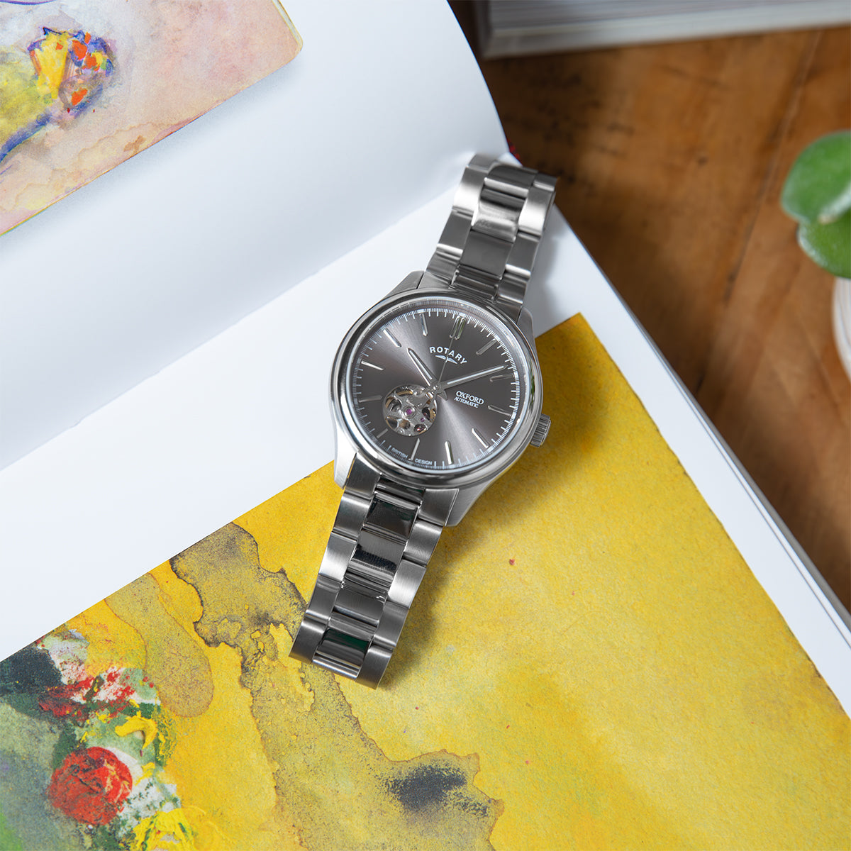 Silver Rotary Oxford watch on a colourful surface with a blurred background
