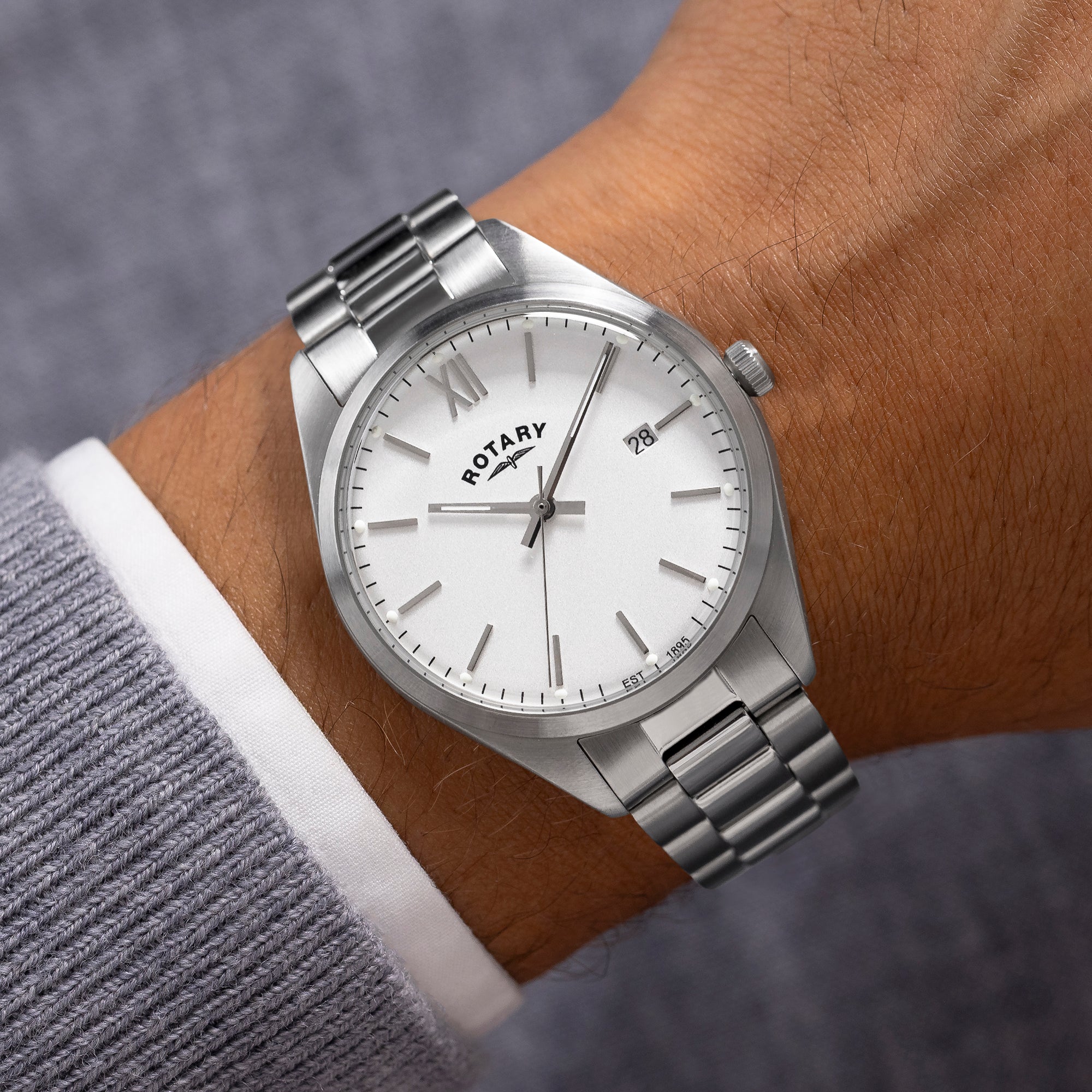 Silver Rotary watch on a wrist with a blurred background