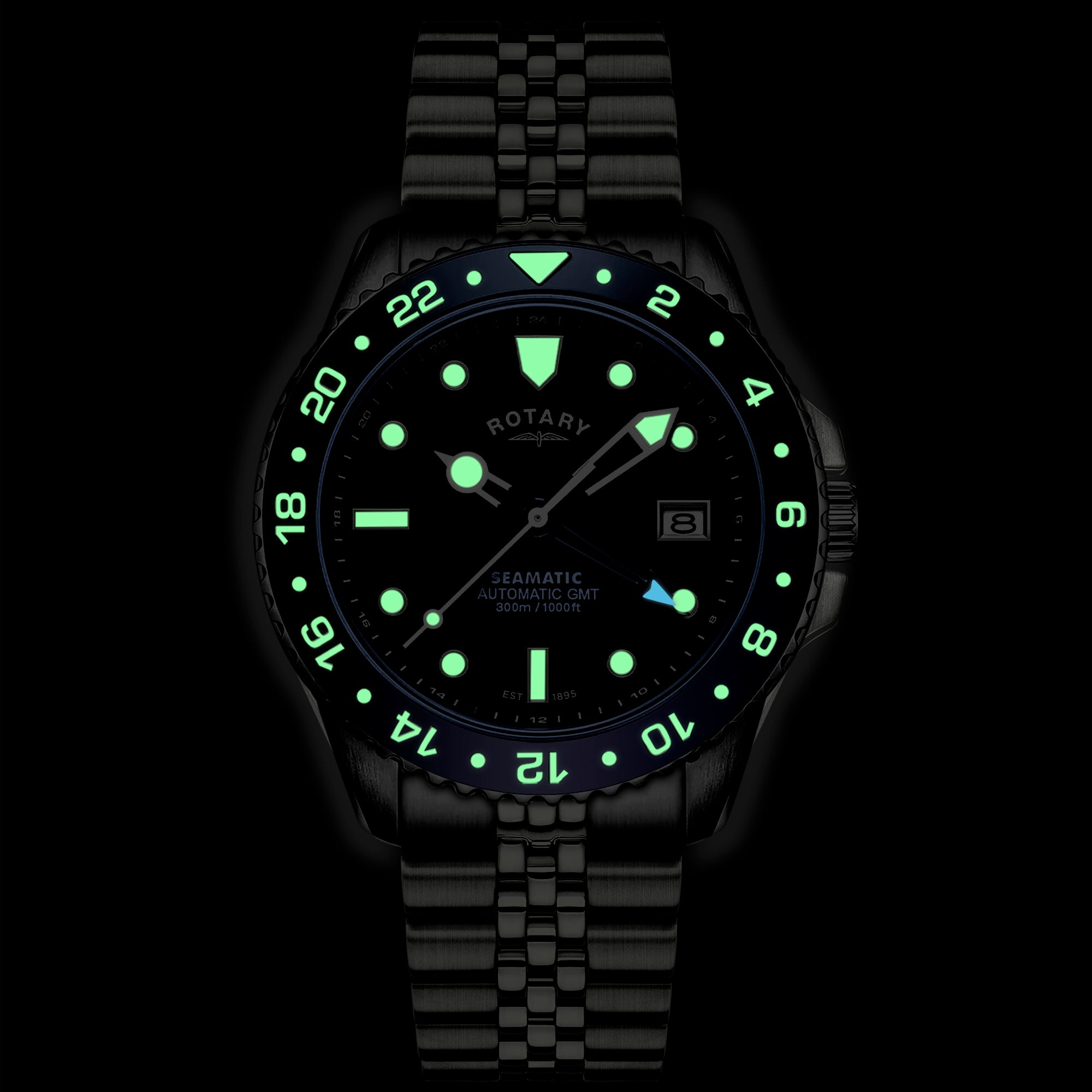 Black Rotary Seamatic wristwatch with green glowing face on a black background