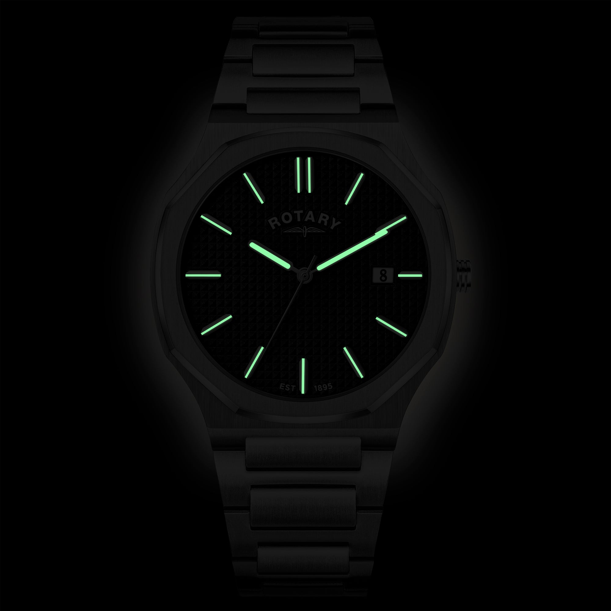 Rotary wristwatch with glowing green face on a black background