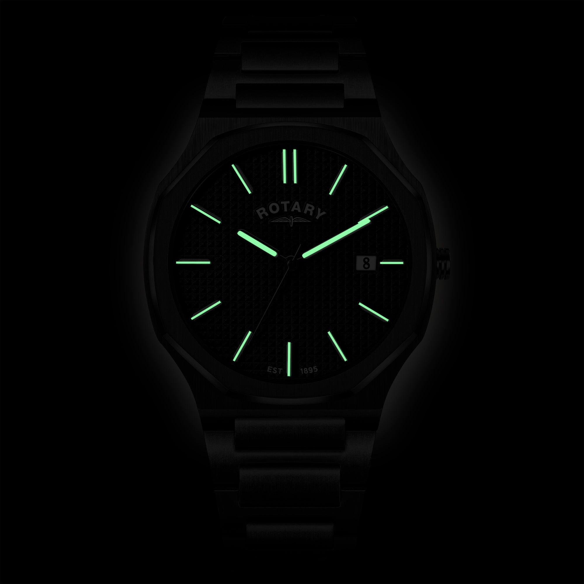 Rotary watch with glowing green face and hands on a dark background
