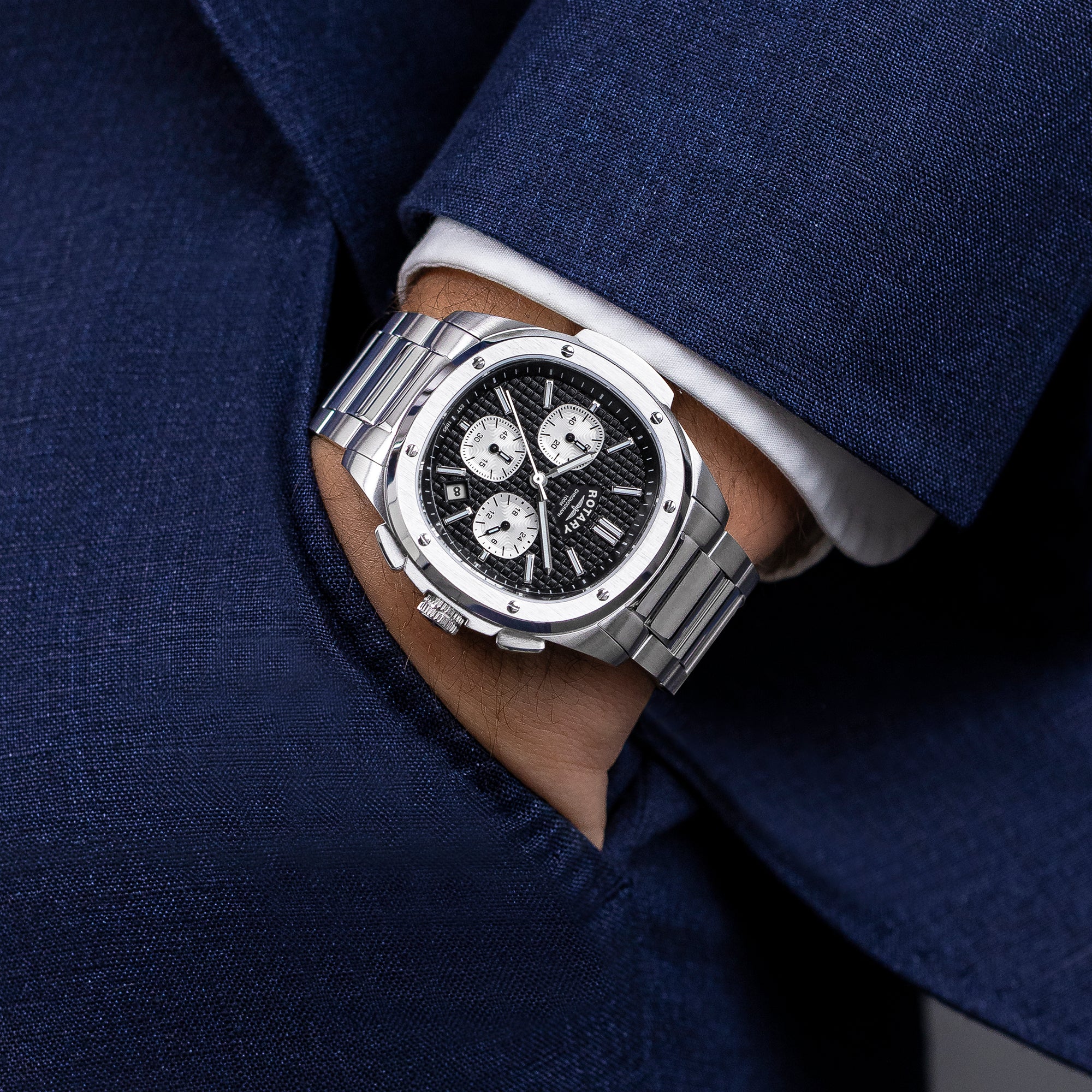 Silver Rotary Apex100 Chronograph watch on a person wearing a blue suit