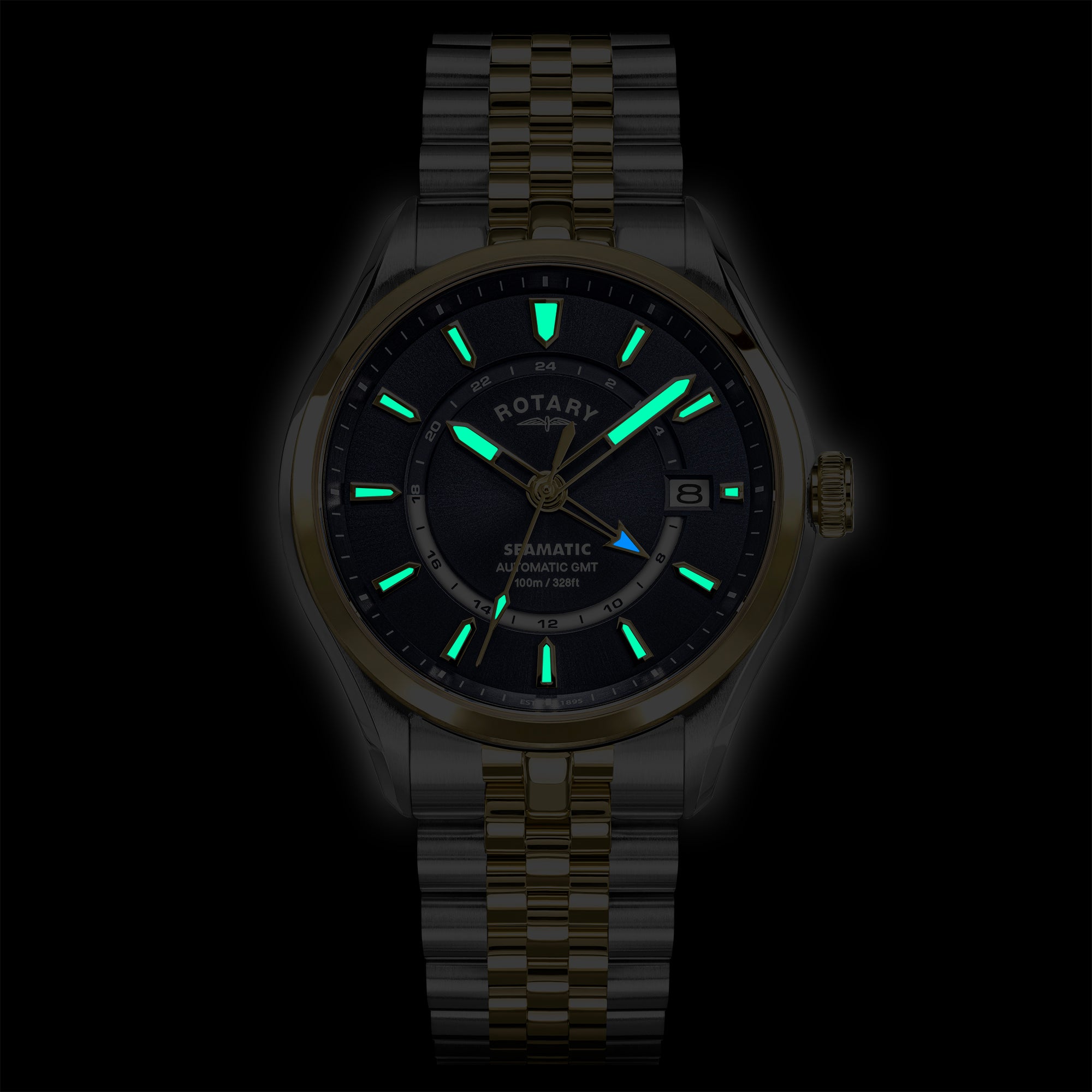 Rotary Seamatic 100 watch with green glowing indices on a black background