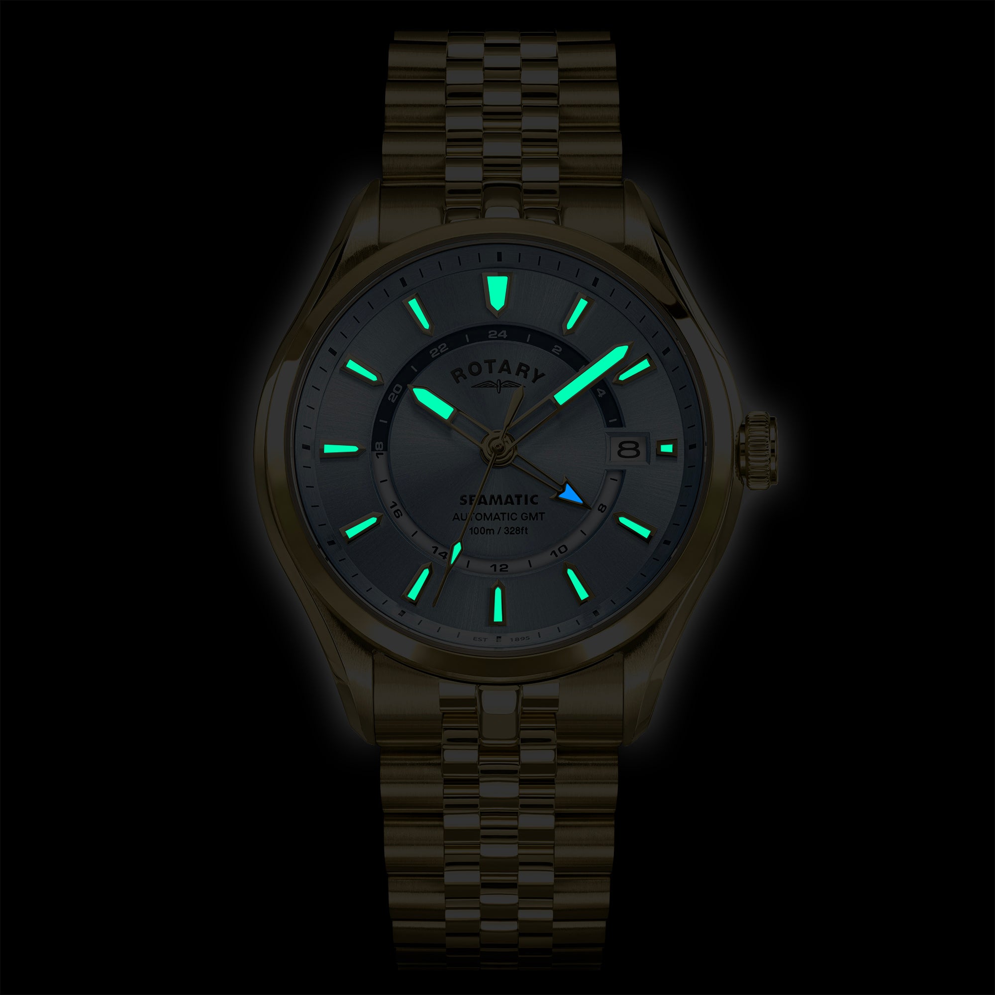 Rotary Seamatic 100 GMT watch with green glowing hands and markers on a dark background