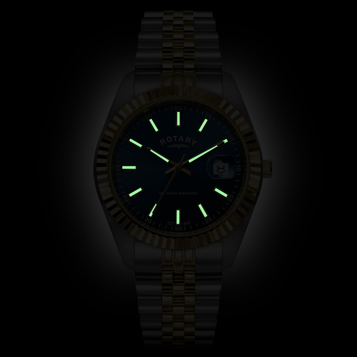 A two-tone Rotary wristwatch with a matching metal link band, shown against a black background. The watch face and bezel are very dark, but the luminous hour markers and hands glow green, and the brand name ROTARY is visible on the dial.