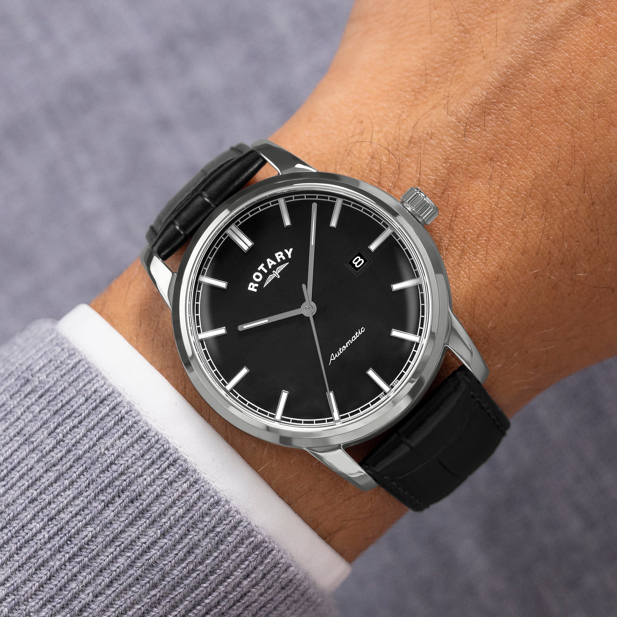 Black Rotary Automatic watch on a wrist with a gray sleeve