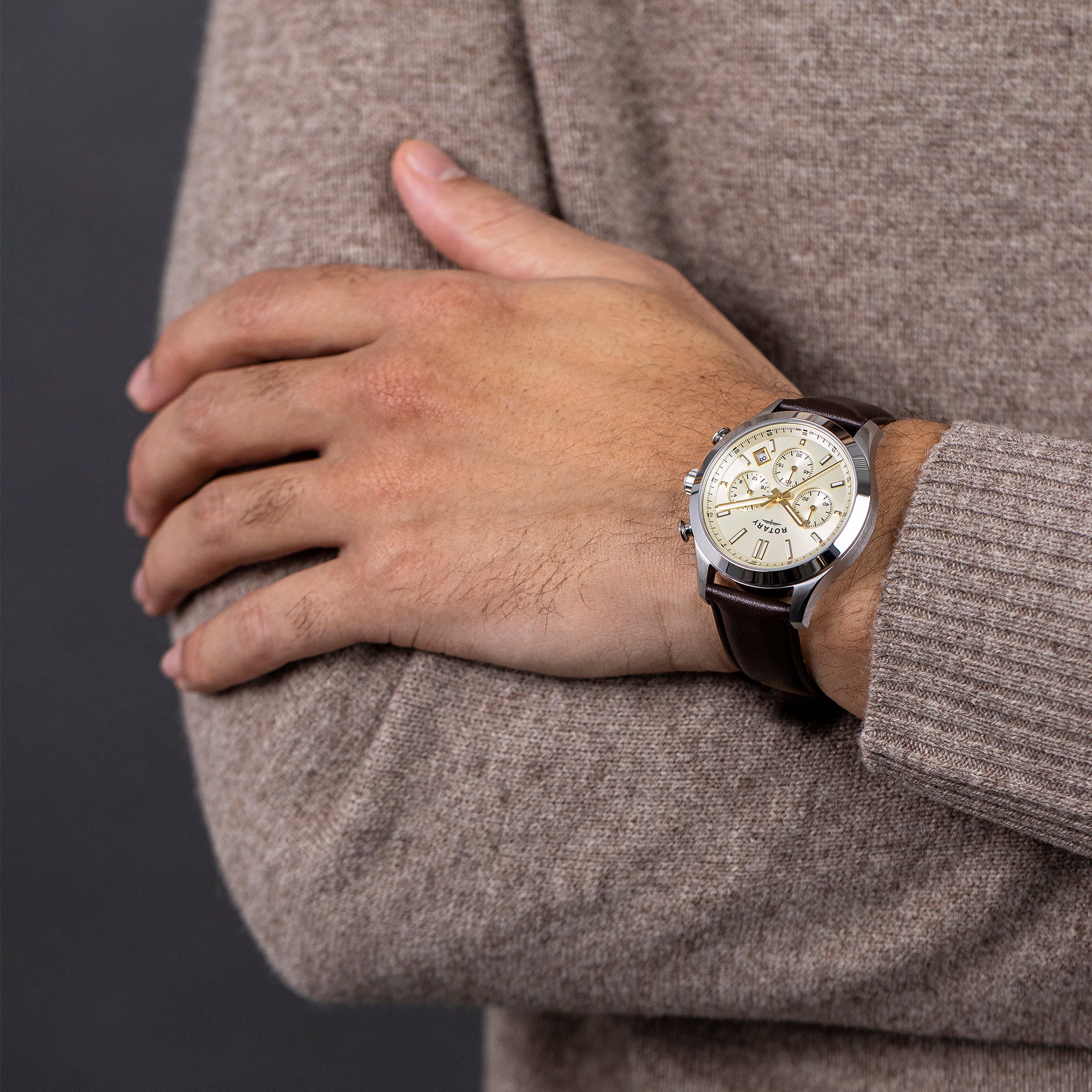 Hand wearing a Rotary Heritage Chronograph watch with a detailed face, against a neutral background
