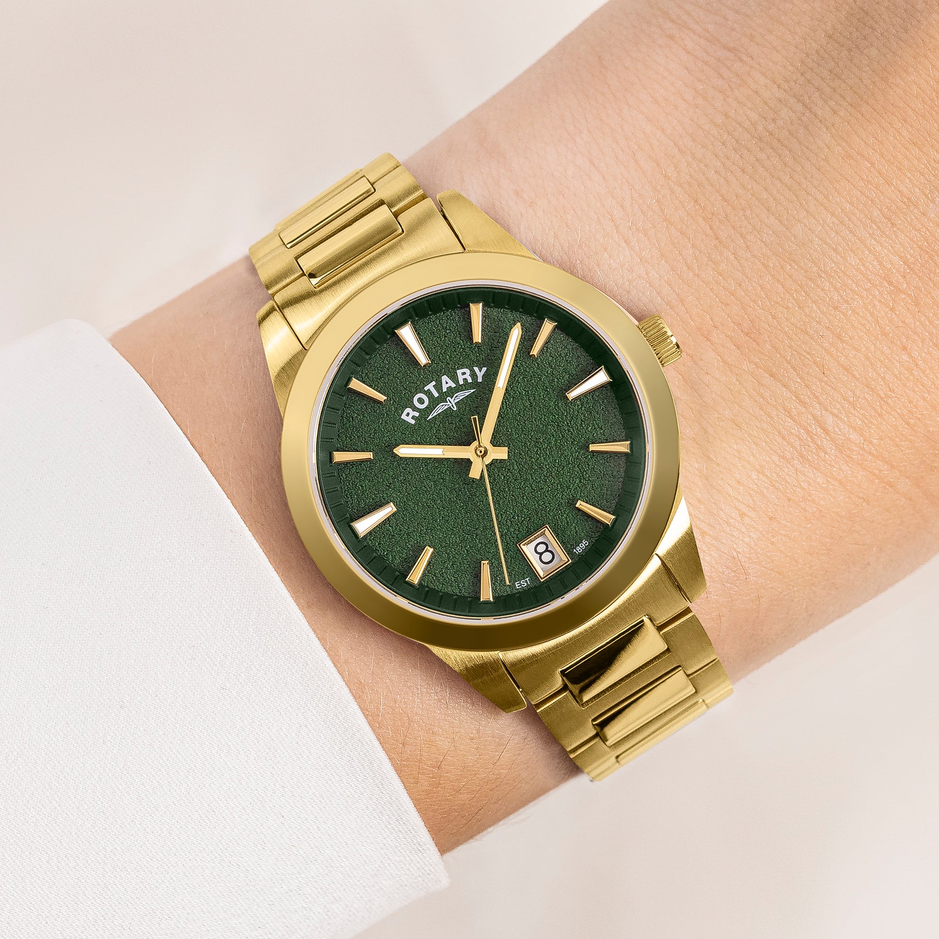 Gold Rotary wristwatch with green dial on a wrist