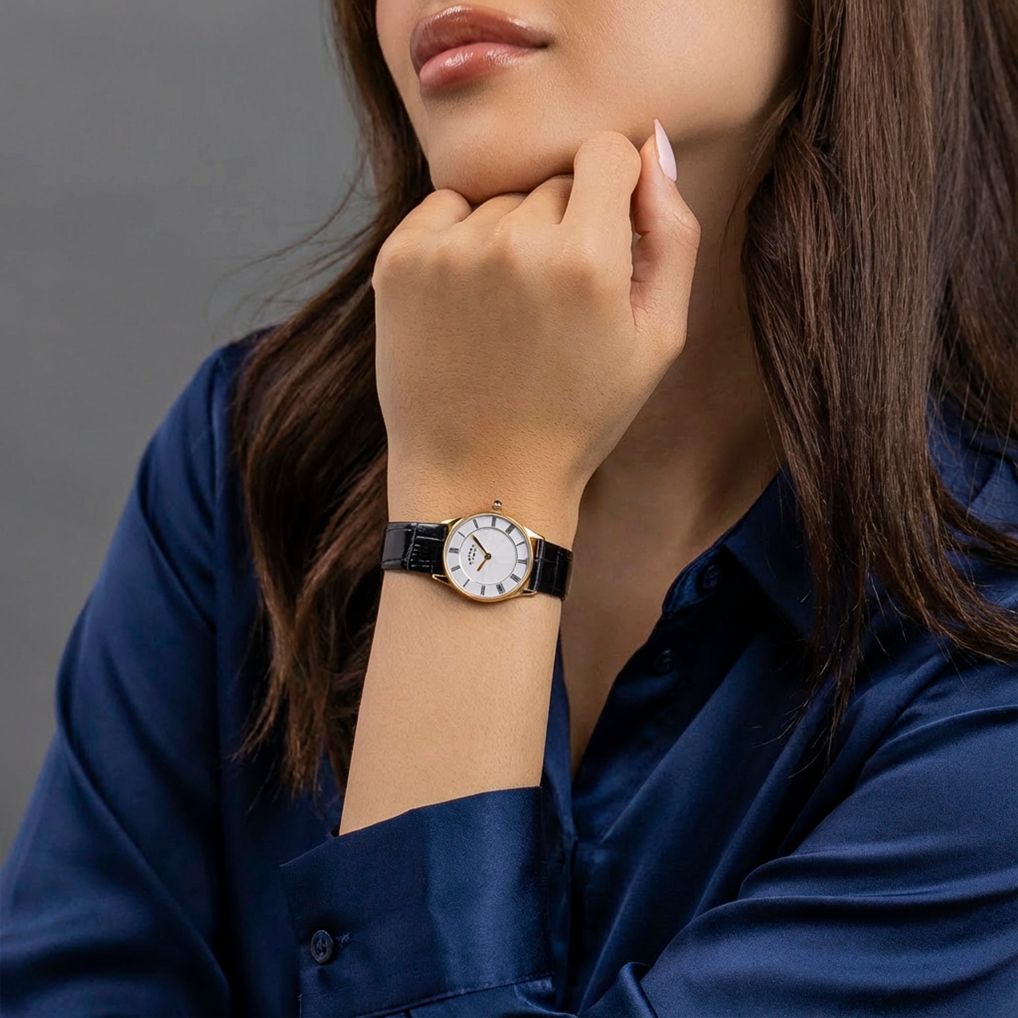 Woman wearing a Rotary Heritage watch with a gray background
