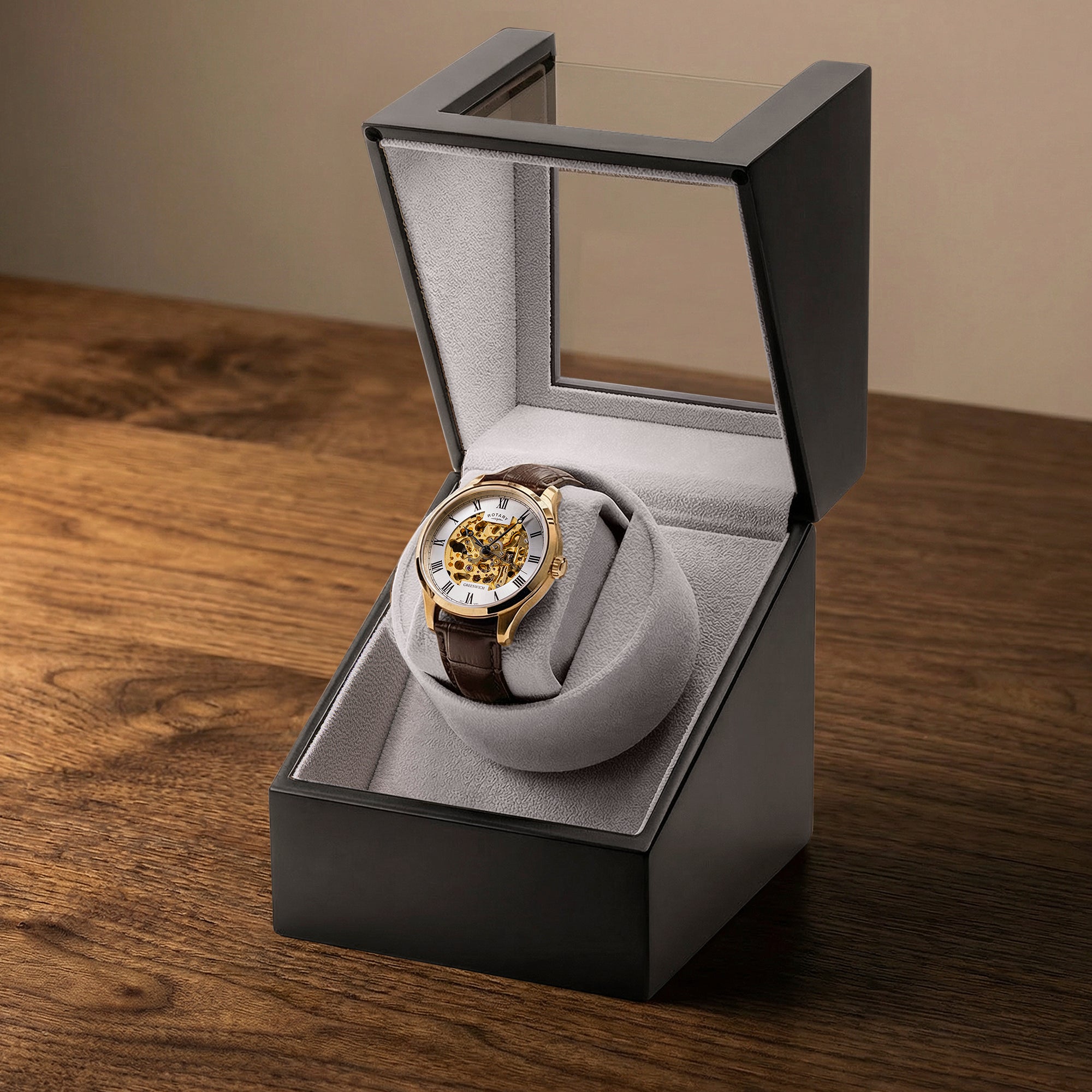 Luxury Rotary Greenwich automatic watch in a black Rotary watch winder display box on a wooden surface