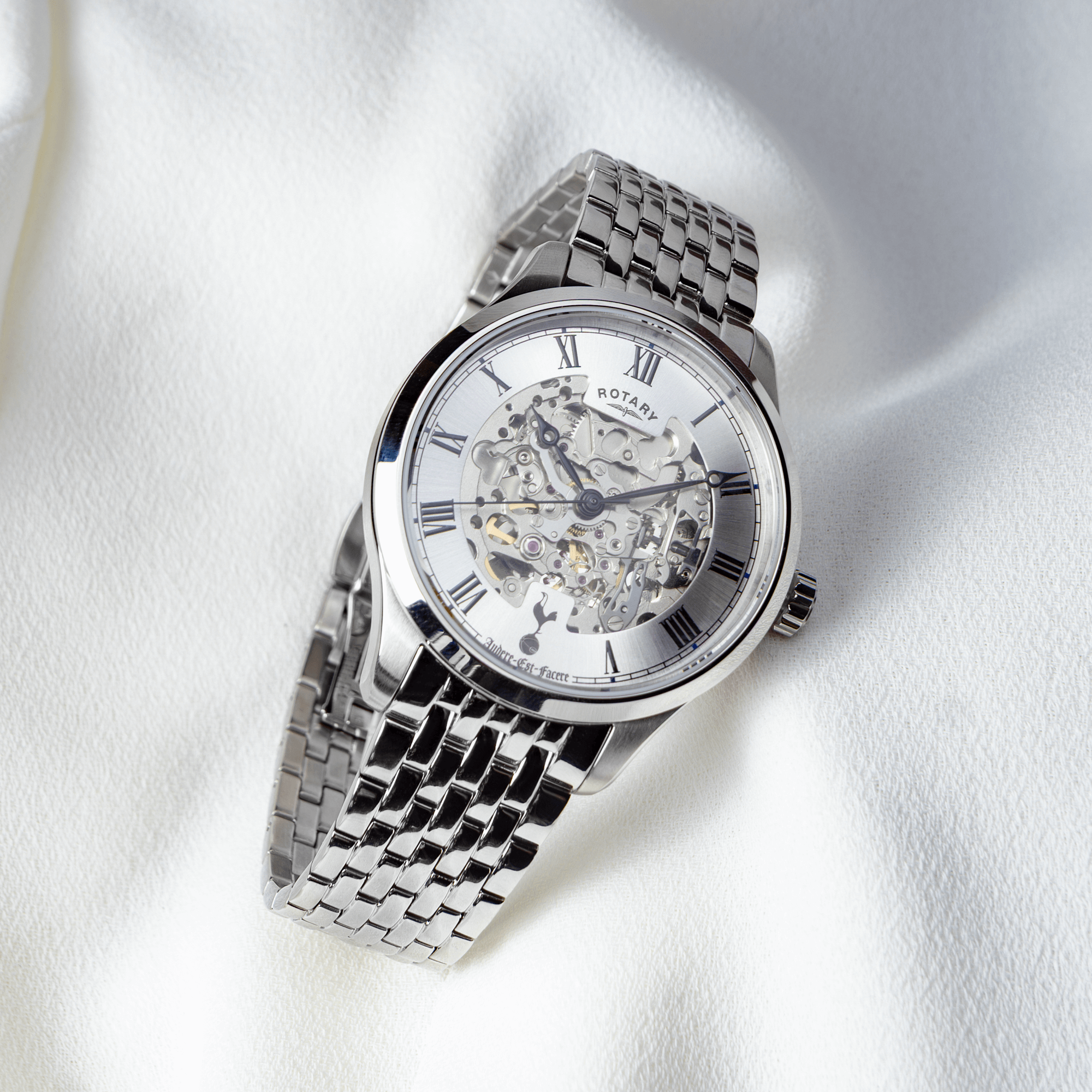 Silver Rotary wristwatch with a detailed face on a white fabric background