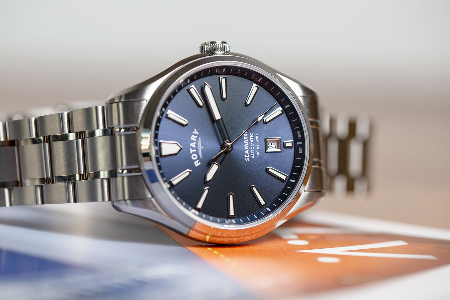 Silver rotary Seamatic 100 watch with blue dial on a blurred background