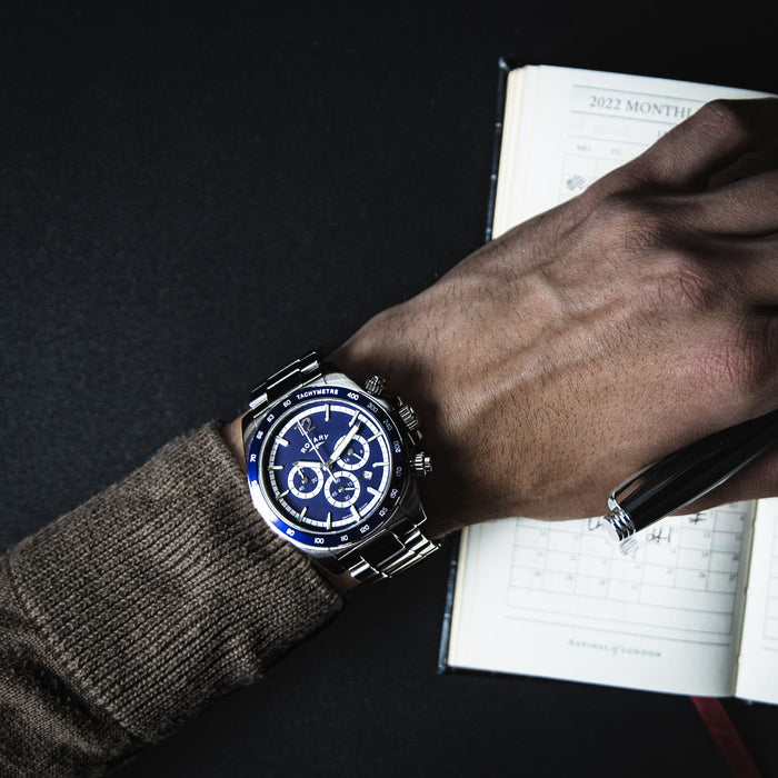 a man wearing a Rotary chronograph watch in stainless steel with a blue bezel and blue dial