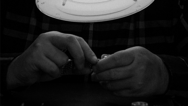 A man repairing a rotary watch movement