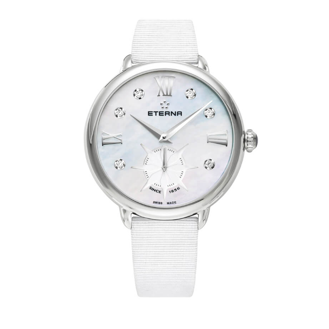 Eterna ladies watch with a white strap, stainless steel case and mother of pearl dial. The mother of pearl dial has roman numerals and diamond indexes, as well as a running second hand sub-dial