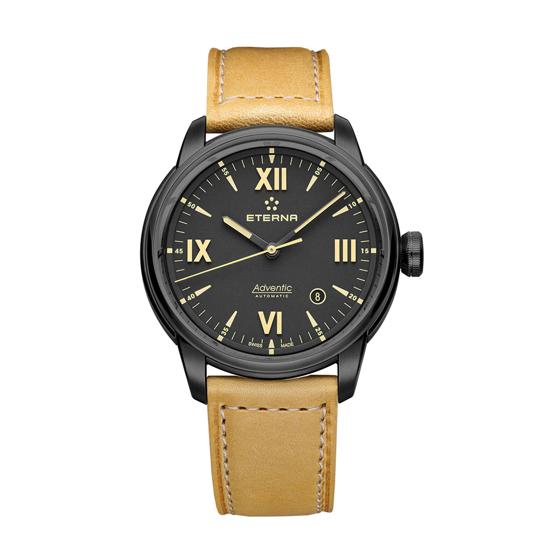 Eterna mens Adventic watch with a black case and black dial with tan coloured lume accenting. The watch features a tan leather strap with white stitching