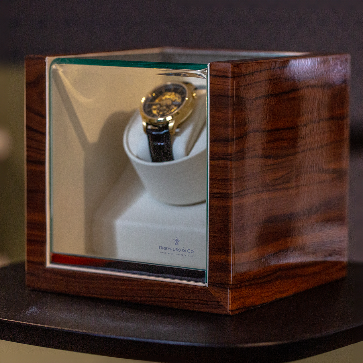 A gold watch in a dreyfuss & co watch winder