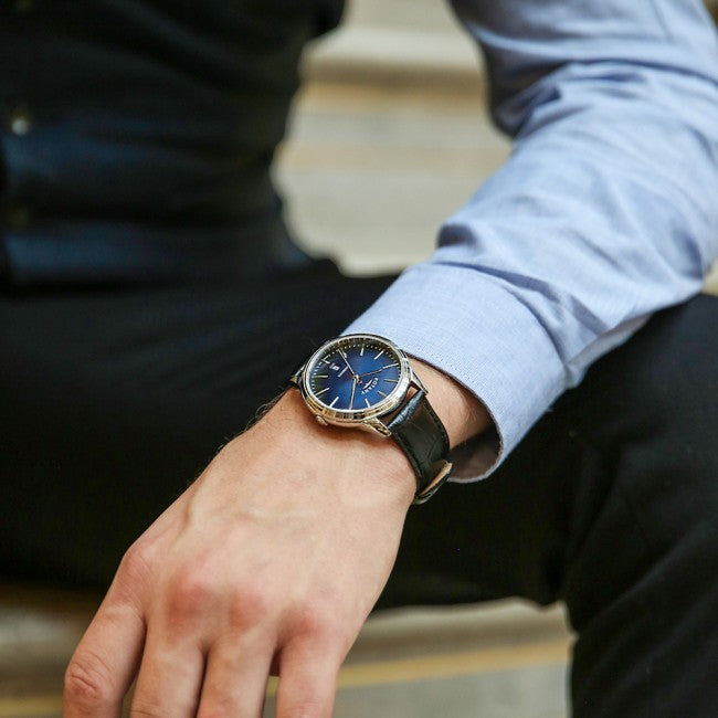 A man wearing a rotary mens watch and a suit