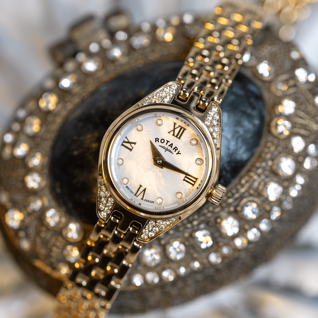 Ladies Rotary watch in gold with a mother of pearl dial and diamond indices. The watch is placed on a ladies jewellery box 