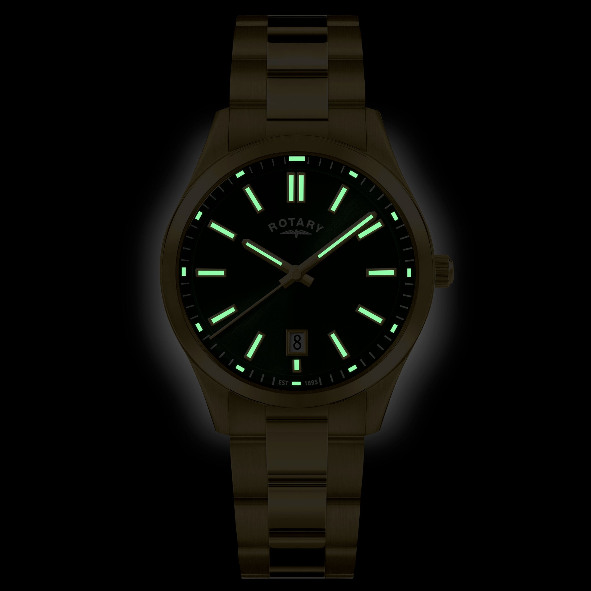 Gold Rotary watch with glowing green lume on a black background