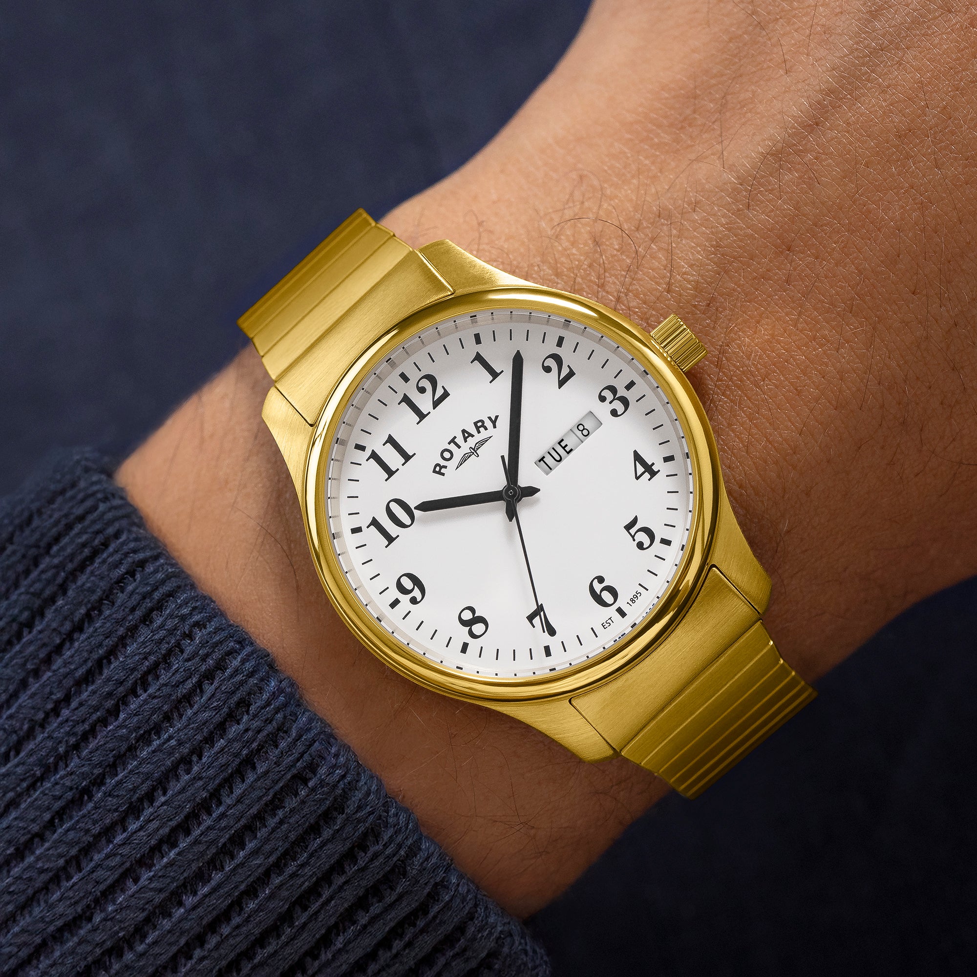 Gold Rotary men's expander wristwatch with a white dial on a wrist
