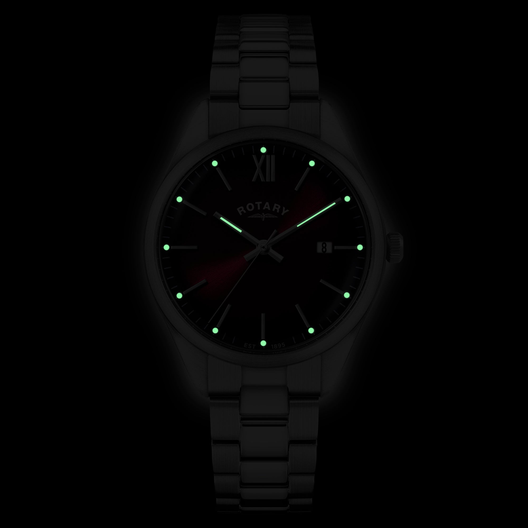 Stainless steel Rotary wristwatch with glowing lume indices on a black background.