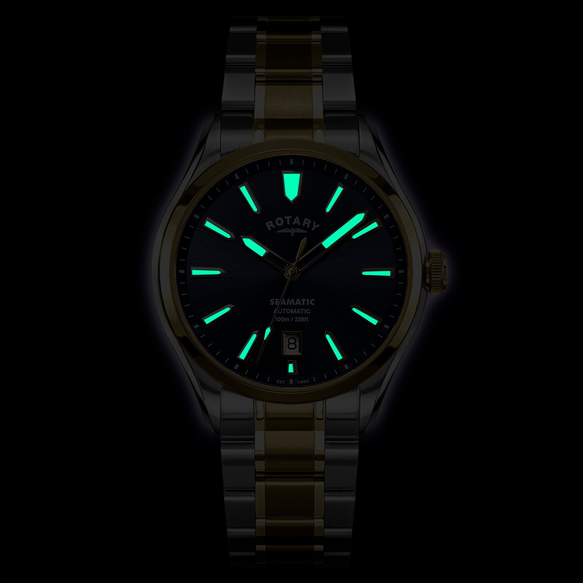Glowing Rotary Seamatic 100 watch face with green luminescent markers on a dark background