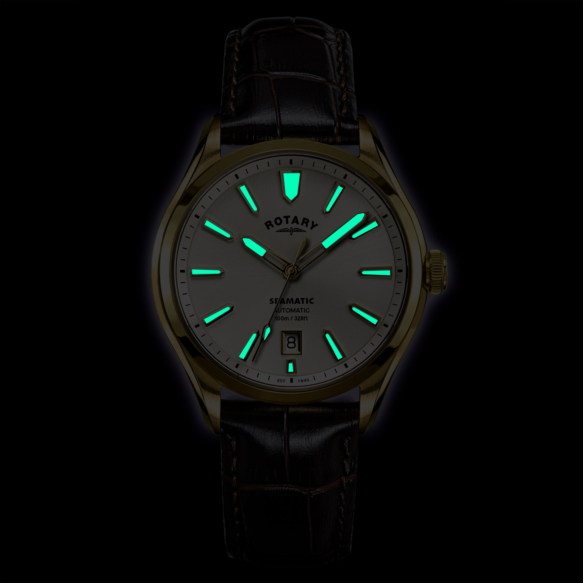 Rotary Seamatic 100 watch with glowing green faces on a black background