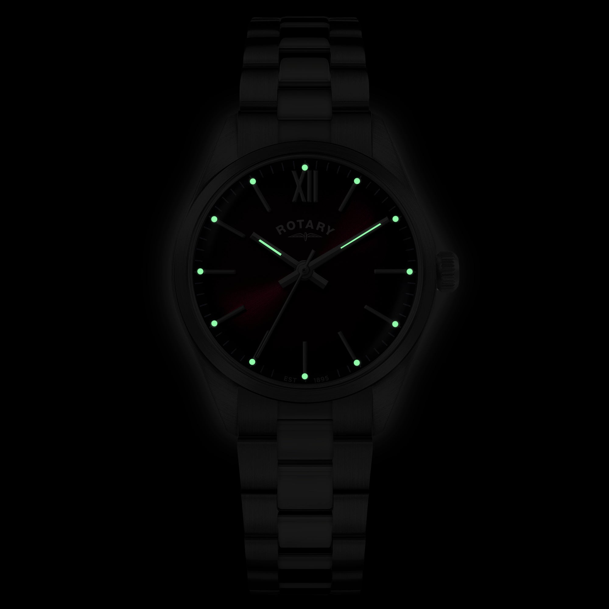 Rotary wristwatch with glowing indices on a dark background