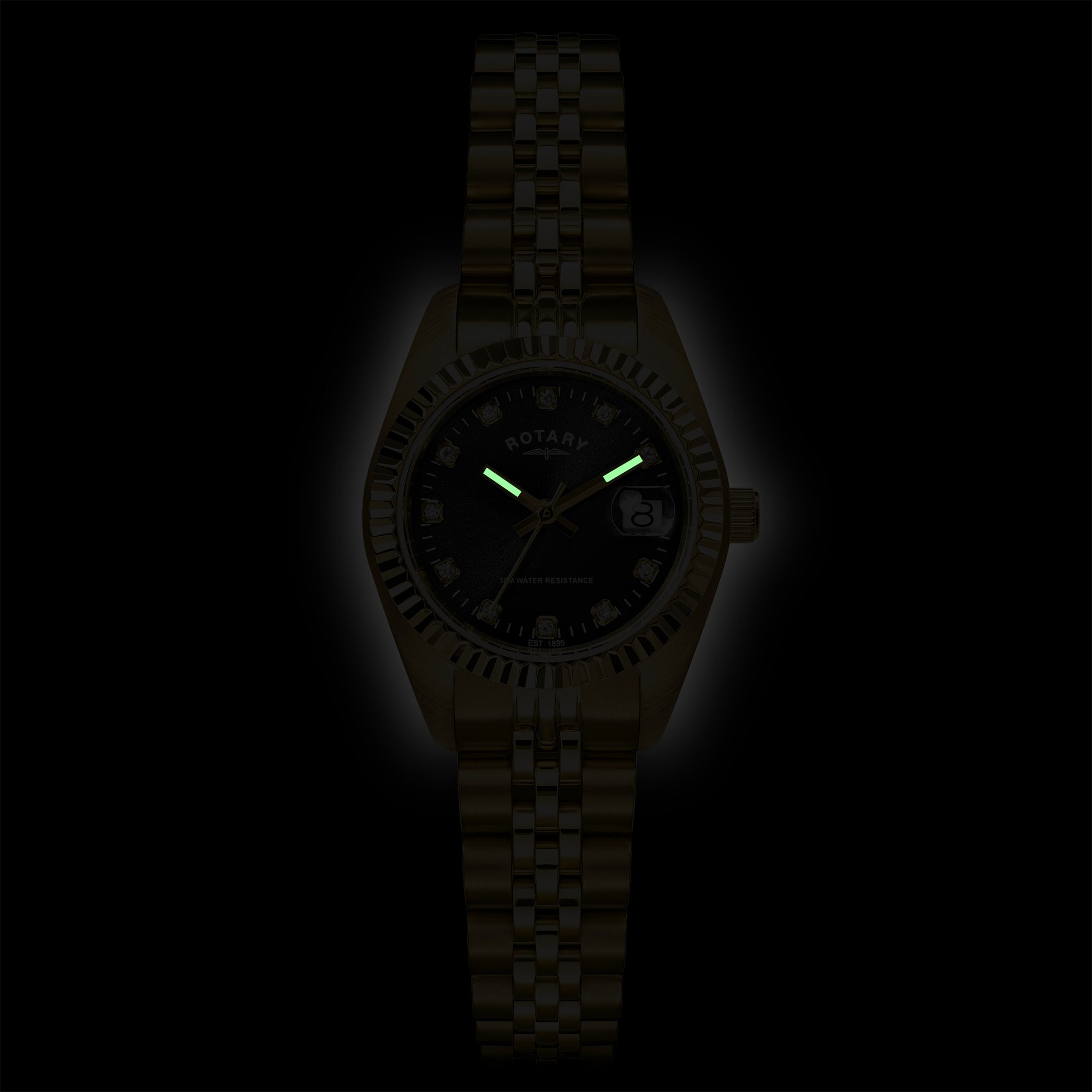 A Rotary Ladies wristwatch with a stainless steel case and link bracelet, featuring a black dial with glowing green hands and markers, shown against a black background.
