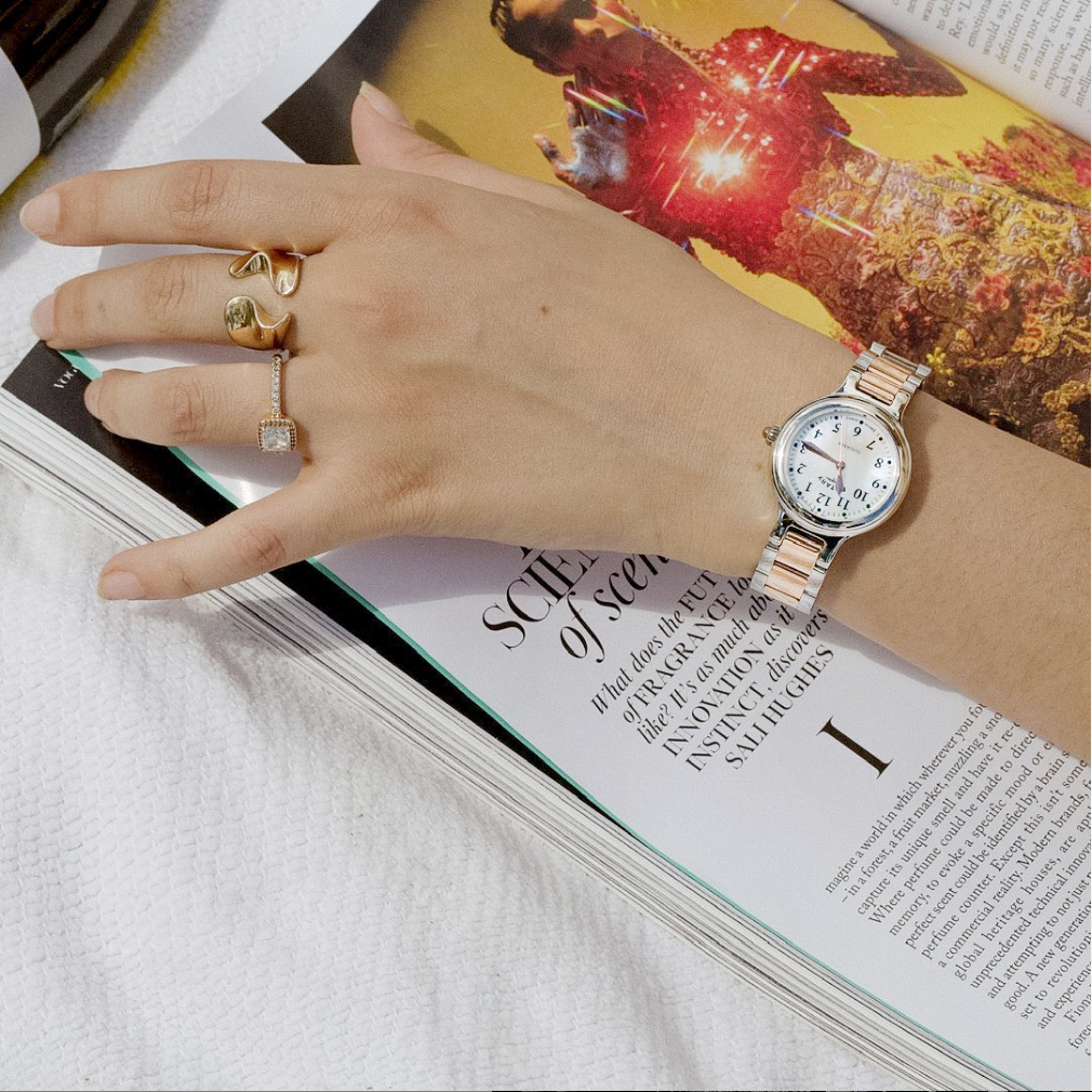 Woman wearing a rose gold two-tone Rotary ladies dress watch