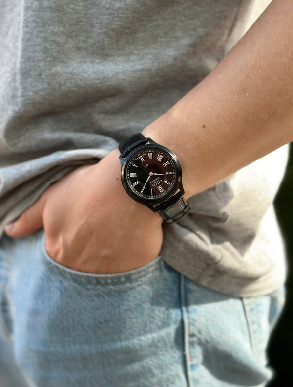 Rotary revelation watch in black being worn by a man in jeans and a t shirt