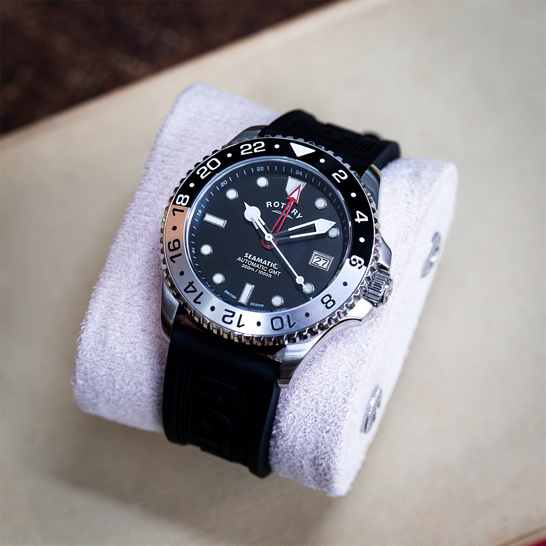 Rotary seamatic automatic watch with a stainless steel case, a black dial, a red GMT hand and a black silicone dive strap