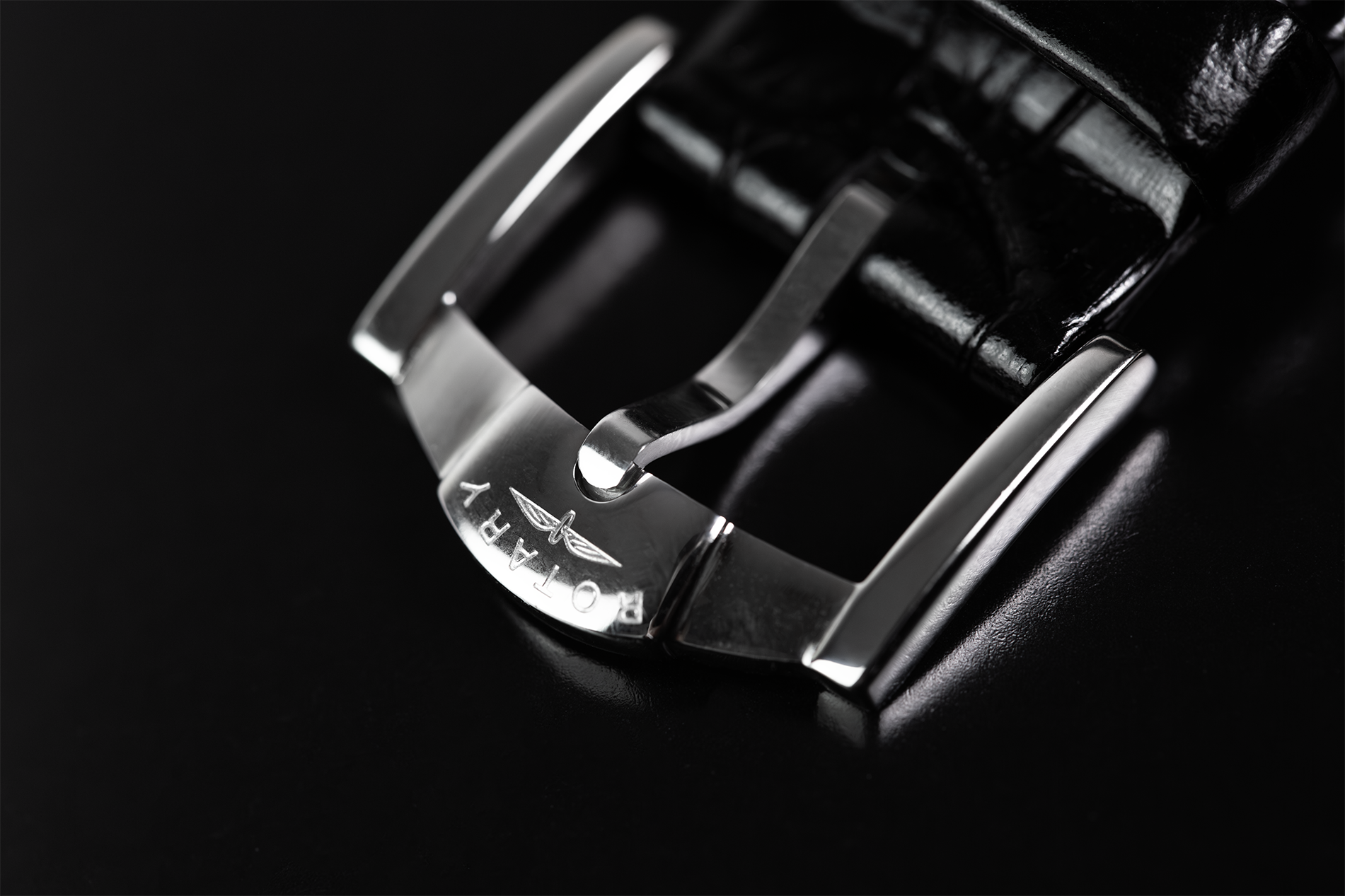 Close-up of a Rotary watch buckle on a black background