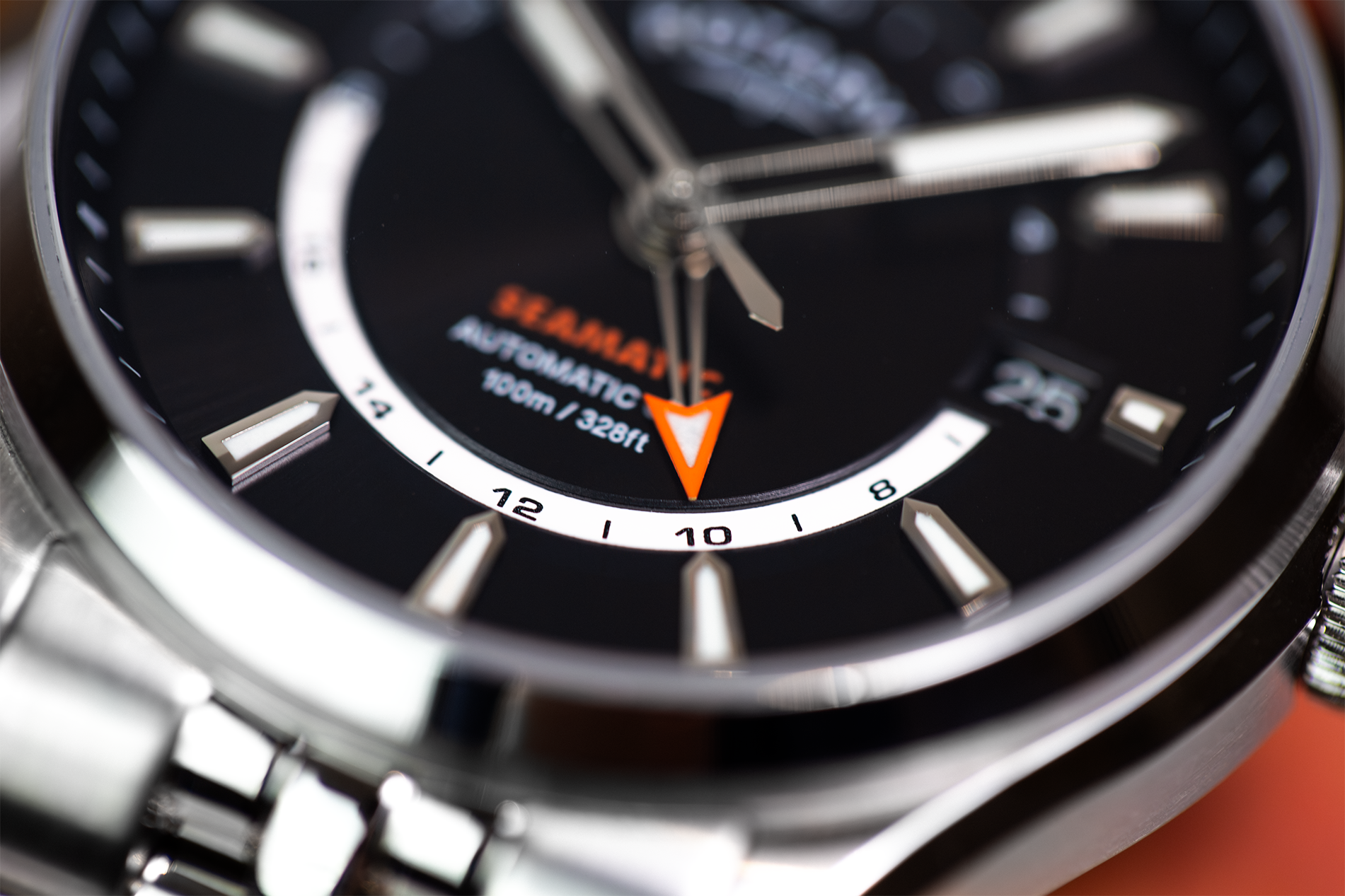 Close-up of a Rotary Seamatic 100 watch with black dial and silver case.