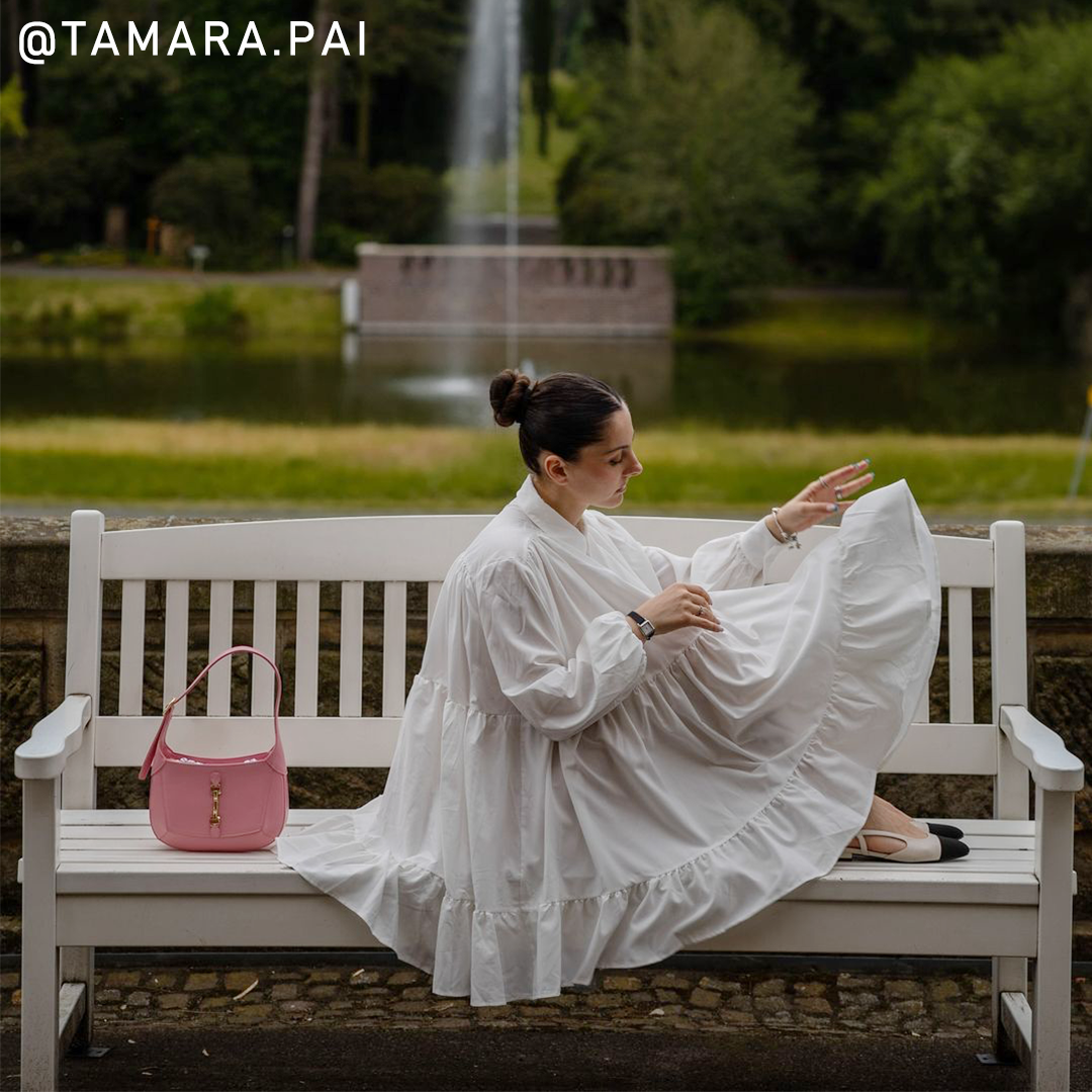 Tamara Pai wearing a Rotary ladies watch whilst sitting on a bench