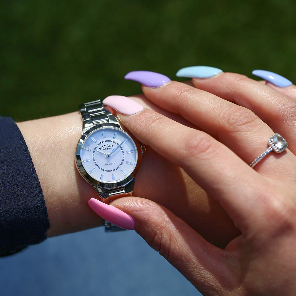 a woman wearing a stainless steel rotary watch